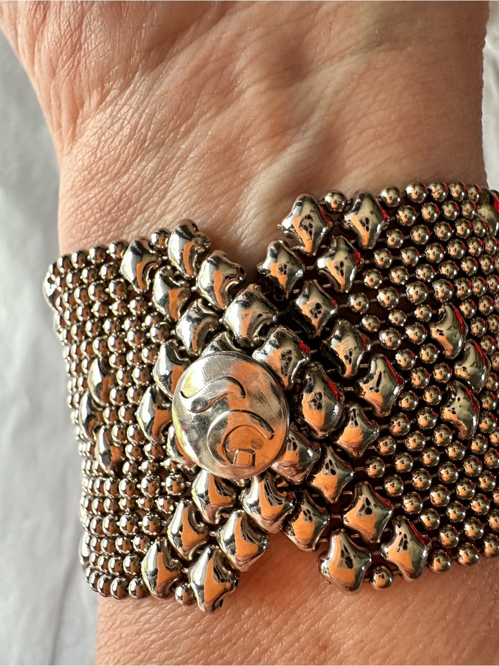Wide Silver-Tone Beaded Cuff Bracelet with Decorative Medallion
